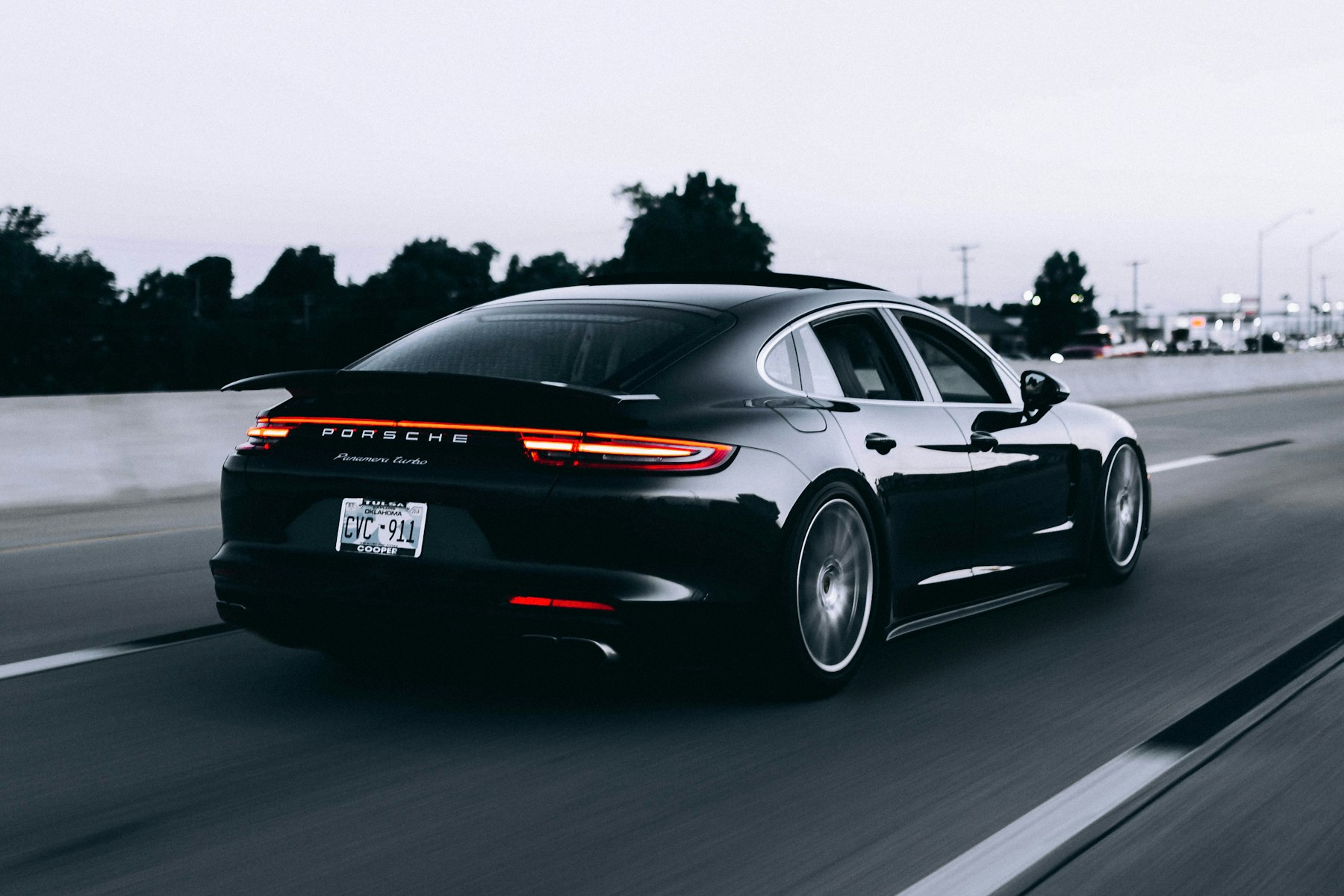 Black premium sedan travelling on an open road